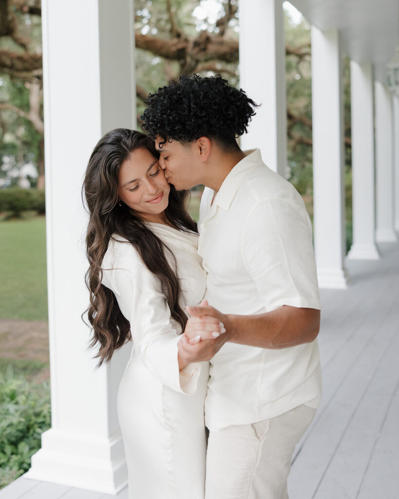 man kisses woman's cheek