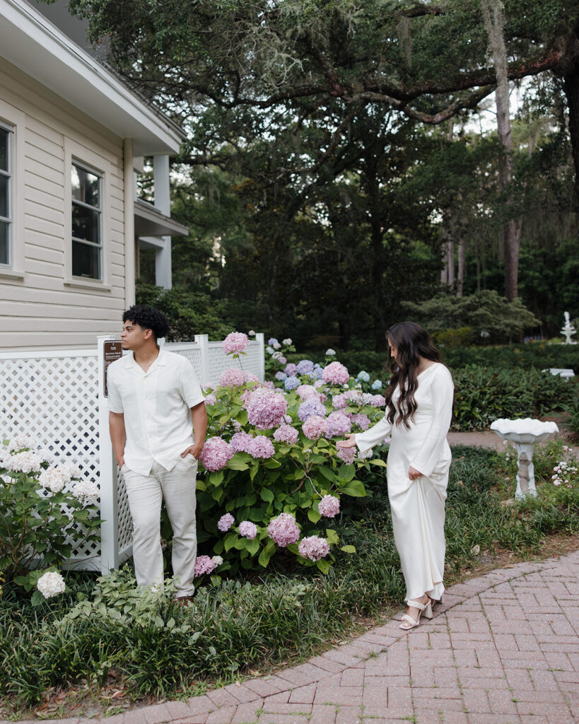 man and woman touch flowers