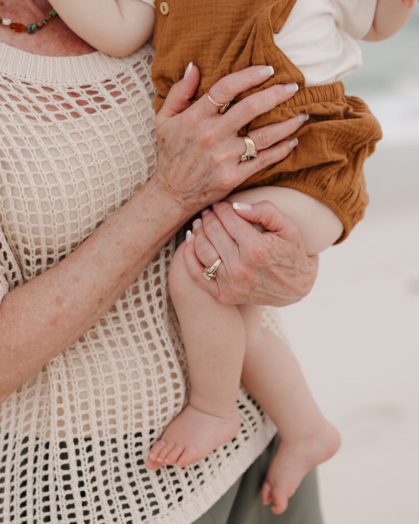 grandma holds her grandson on Pensacola Beach