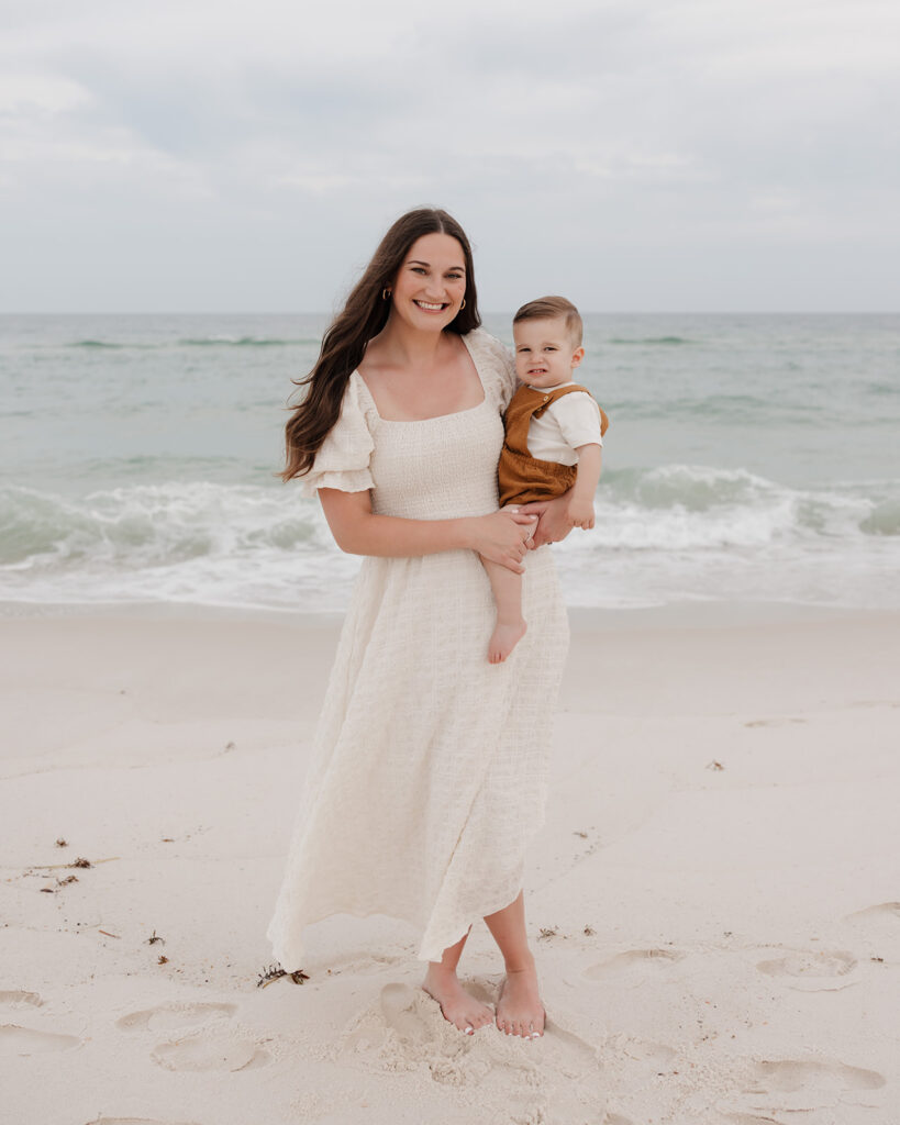 woman holds her son on Pensacola Beach