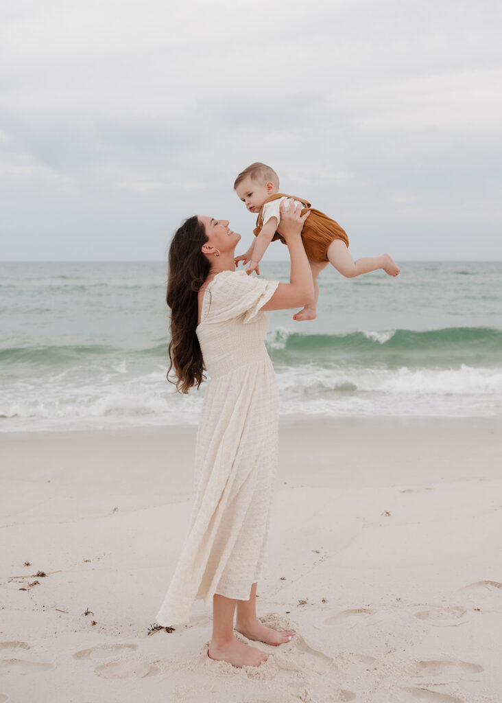 woman plays with her baby on Pensacola Beach