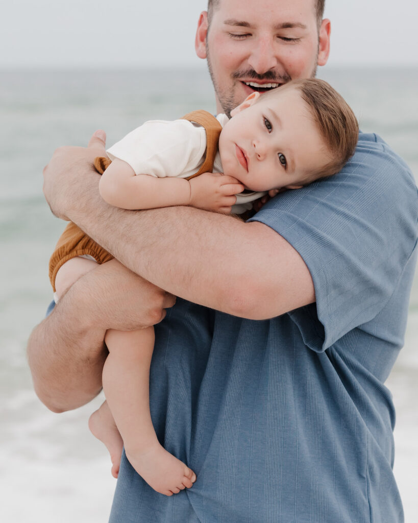 father holds his son