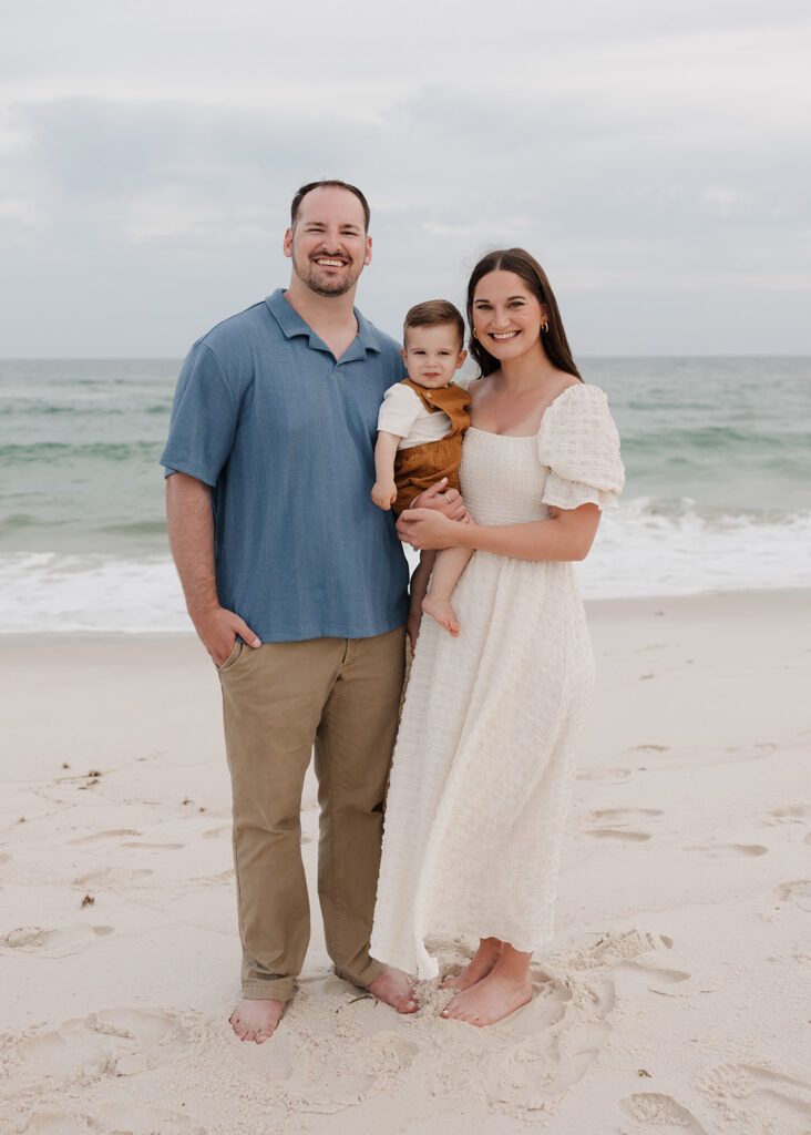 a young family smiles on Pensacola Beach