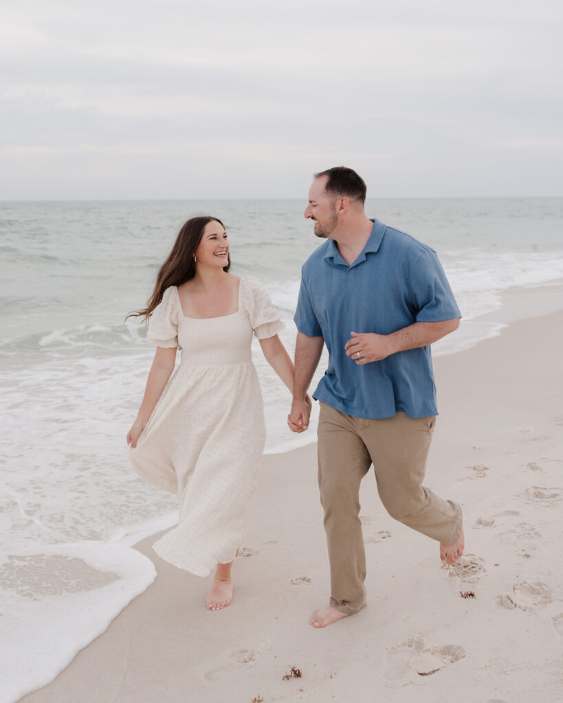 man and woman run on Pensacola Beach