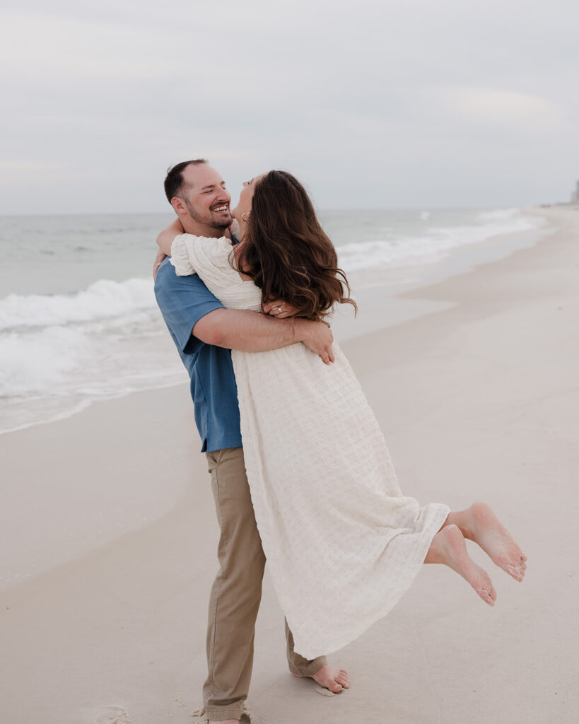 man lifts up woman and spins on Pensacola Beach