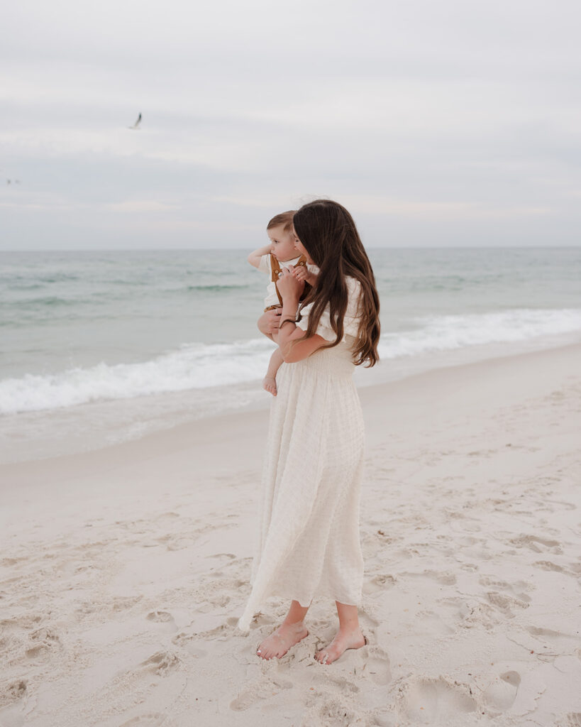 mom and baby look at the water on Pensacola Beach