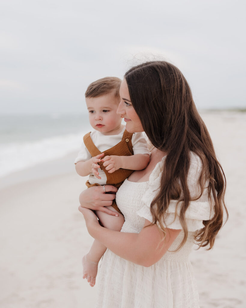 mom and baby look at the ocean