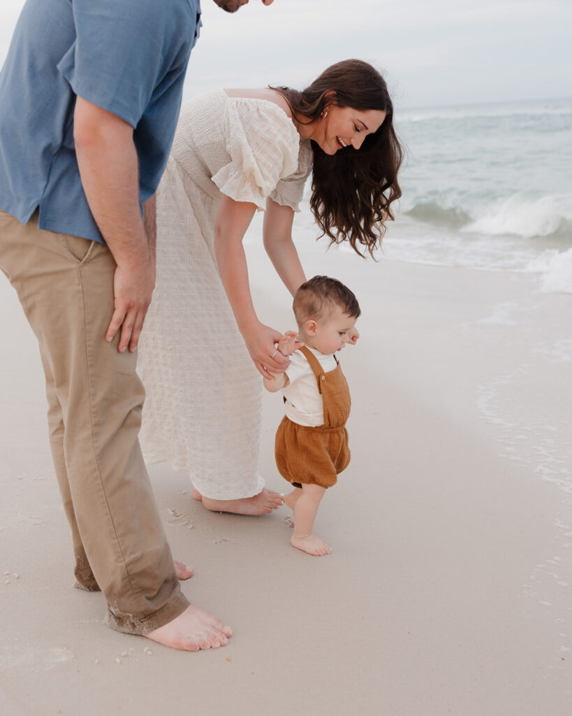 a young family walks up to the water on Pensacola Beach