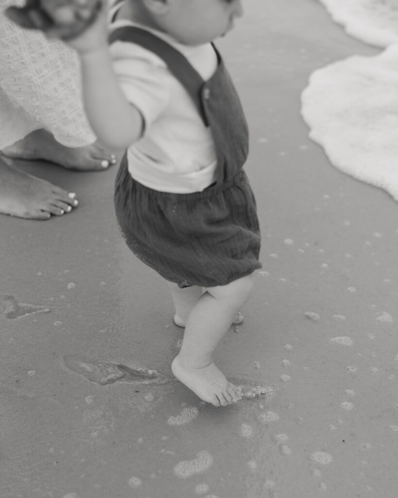 baby walks up to the ocean on Pensacola Beach