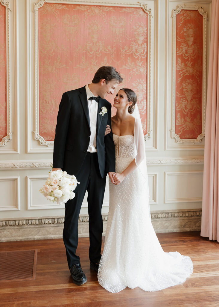 bride and groom smile at each other