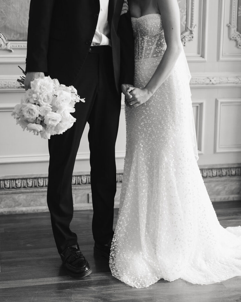 bride and groom hold hands