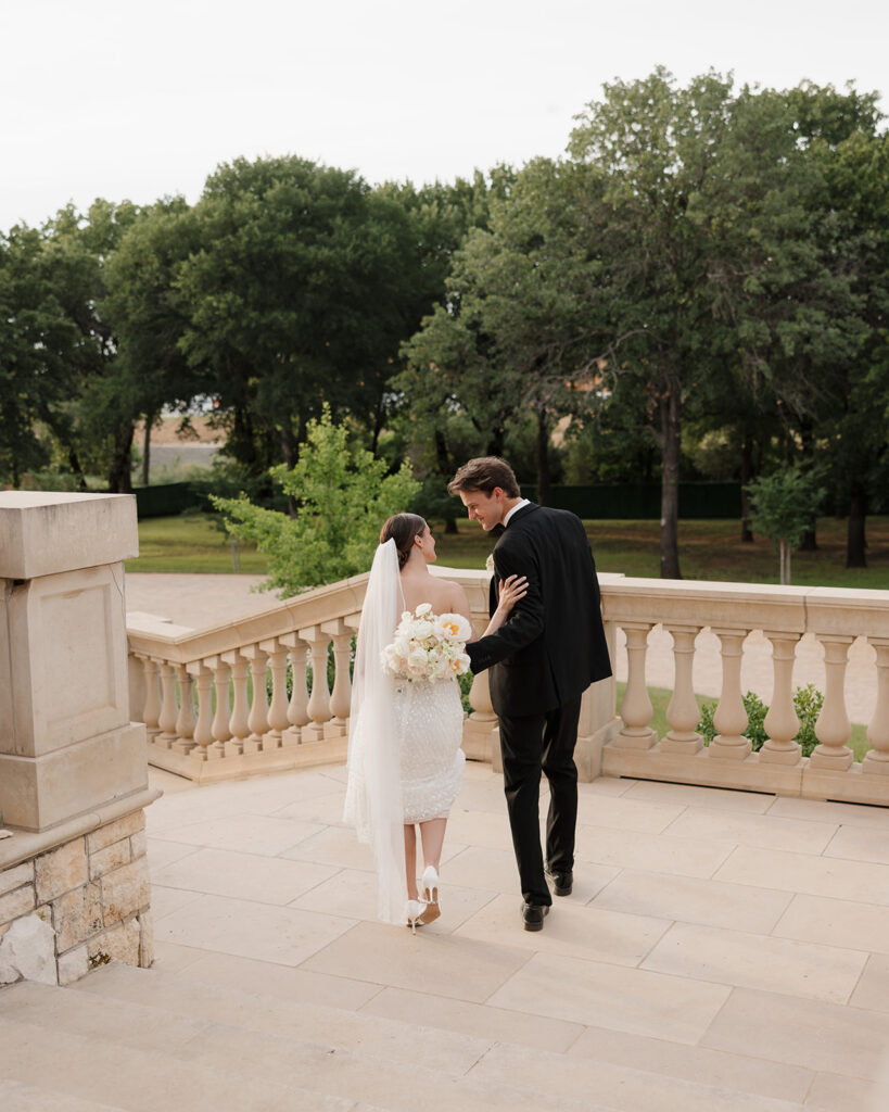 bride and groom walk down the staircase of the Olana