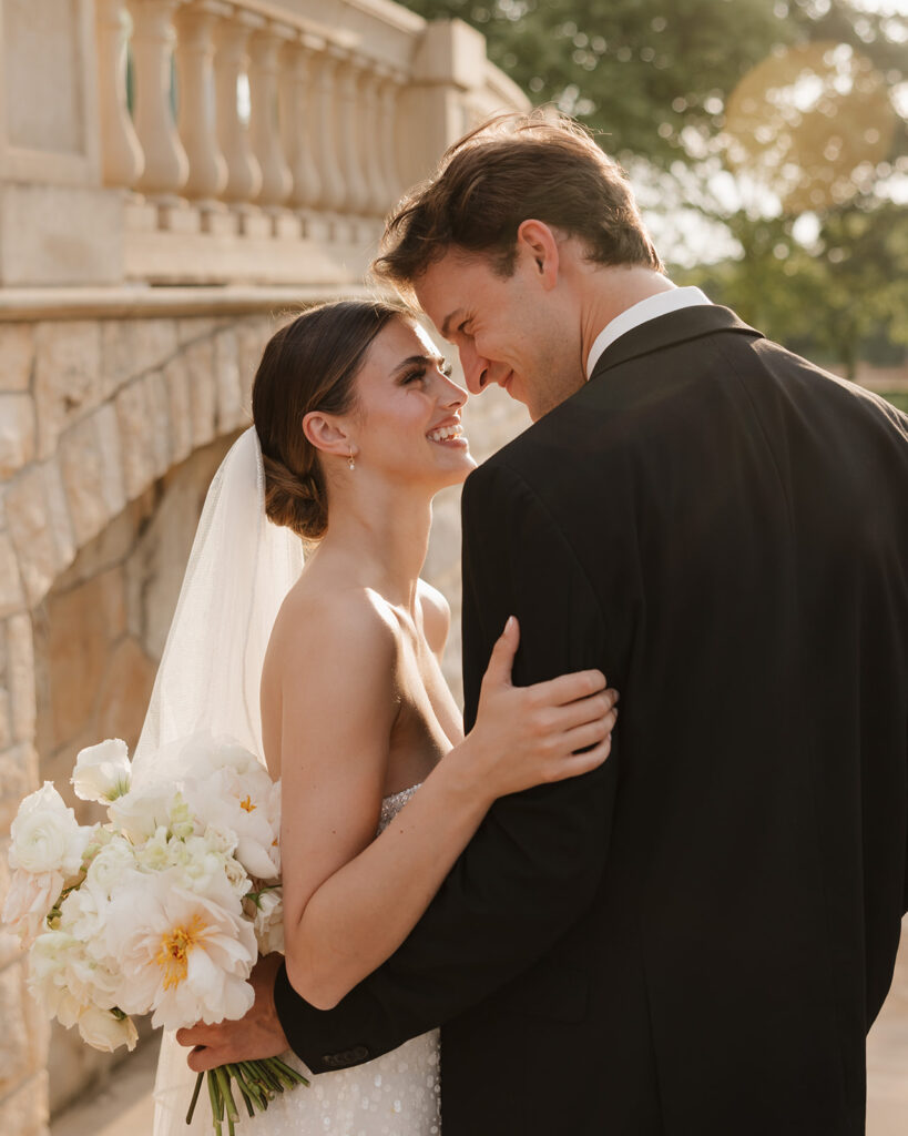 bride and groom smile at each other