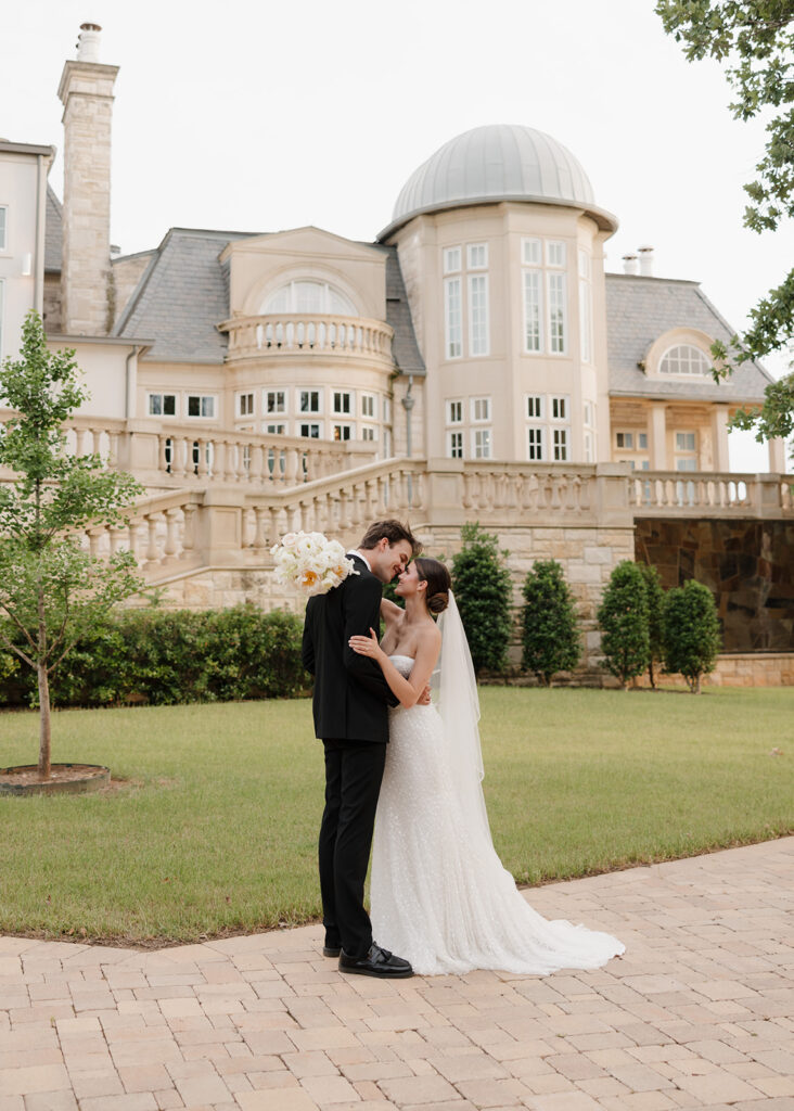 bride and groom kiss outside of the Olana wedding venue