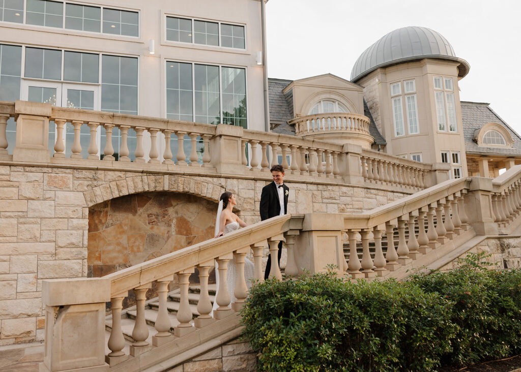 bride and groom walk up the staircase at The Olana