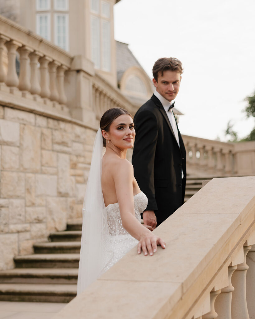 bride and groom walk up the staircase at the Olana