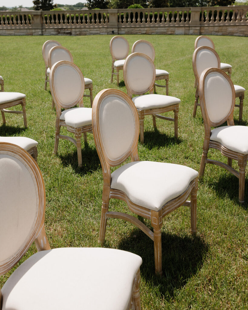 Chairs arranged for a wedding ceremony sit in the Olana's courtyard