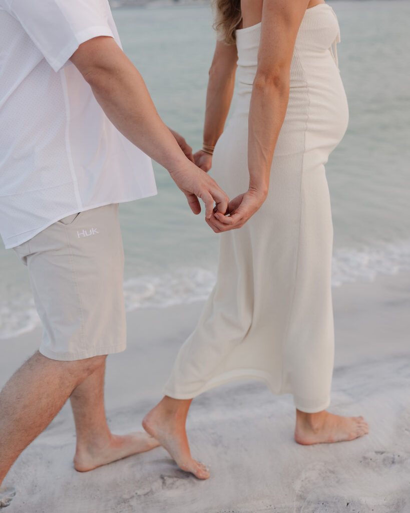 woman leads man on Destin, Florida beach