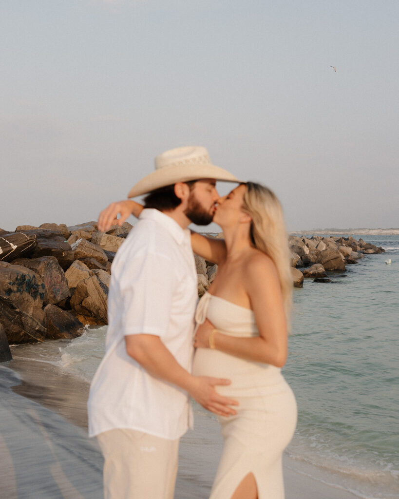 husband and wife kiss on Destin, Florida beach