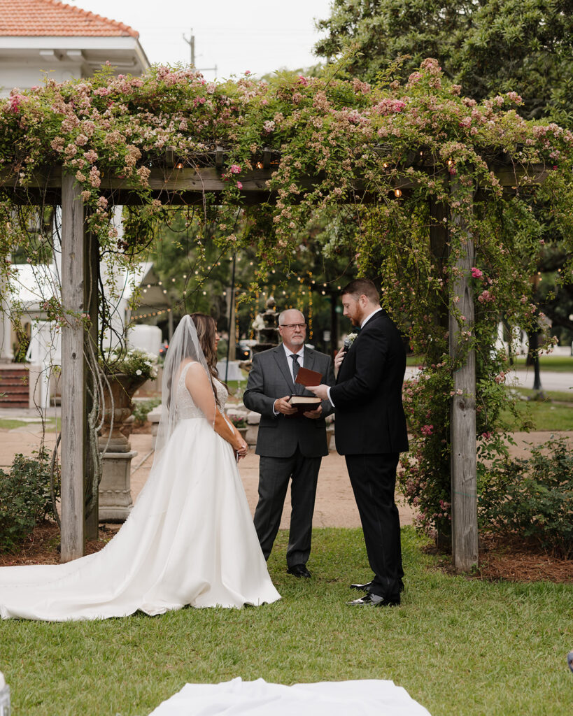 bride and groom share their vows during their wedding ceremony in Mobile, AL