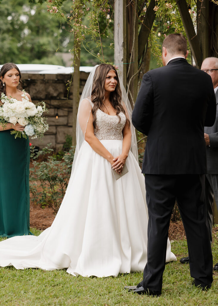bride and groom share their vows during their wedding ceremony in Mobile, AL