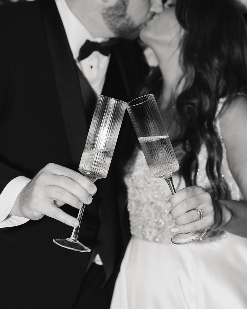 bride and groom cheer with champagne