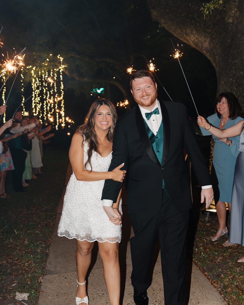 bride and groom run through a tunnel of sparklers