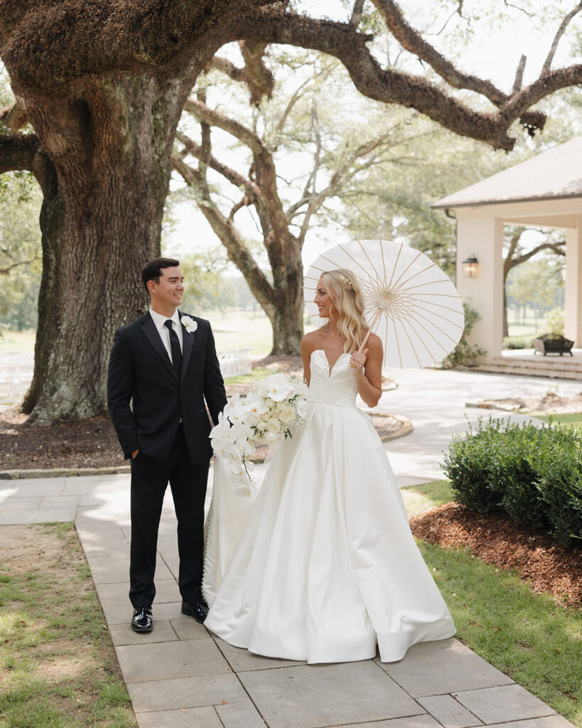 bride and groom walk along the path at the Reed House in Jackson, MS