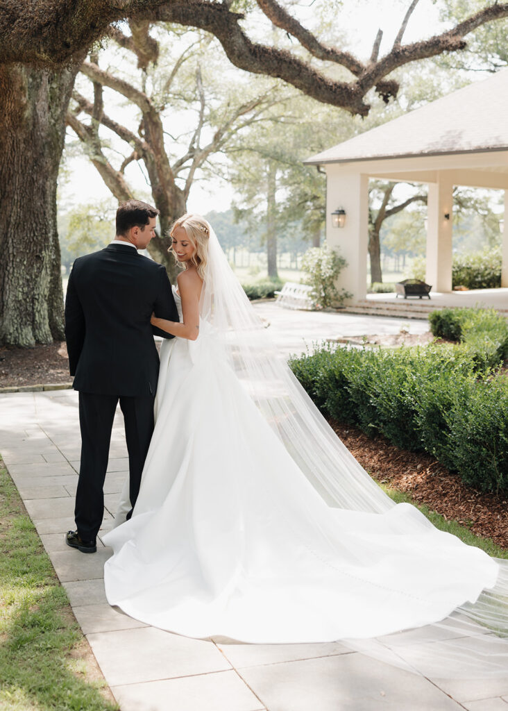 bride and groom walk along the path at the Reed House in Jackson, MS