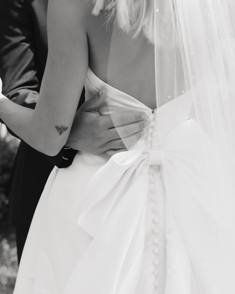 groom holds bride's waist