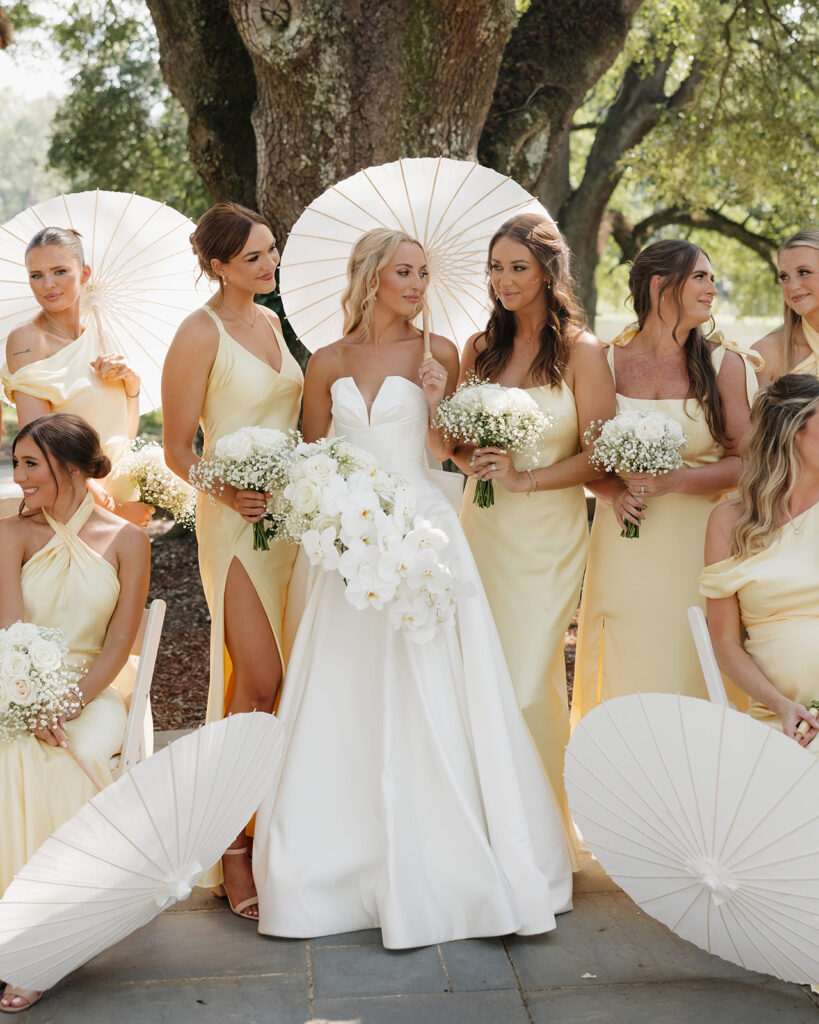 bride and bridesmaids hold parasols at the Reed House in Jackson, MS