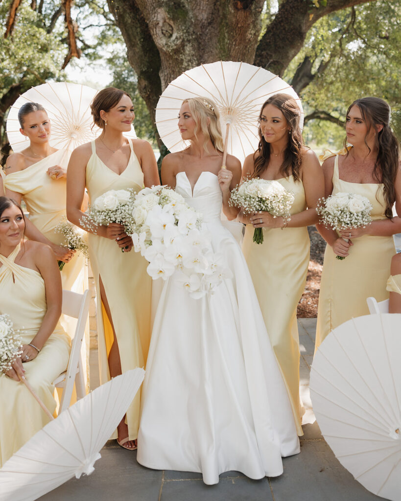 bride poses with her bridesmaids