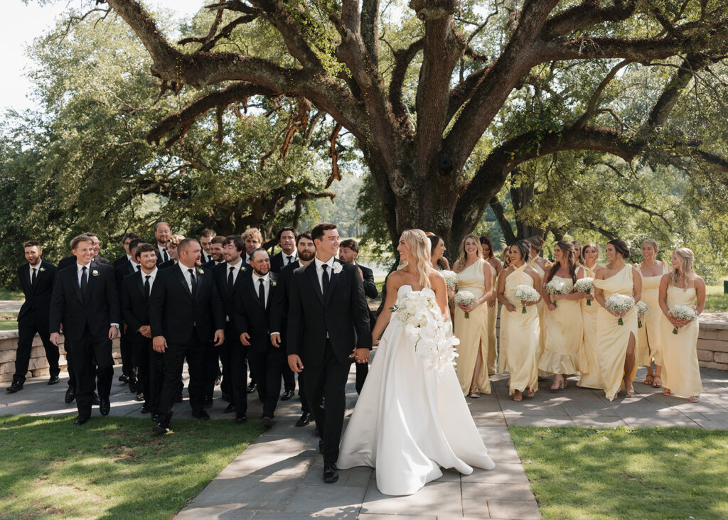 bride, groom, and the wedding party walk