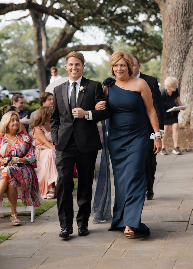 mother of the bride walks down the aisle