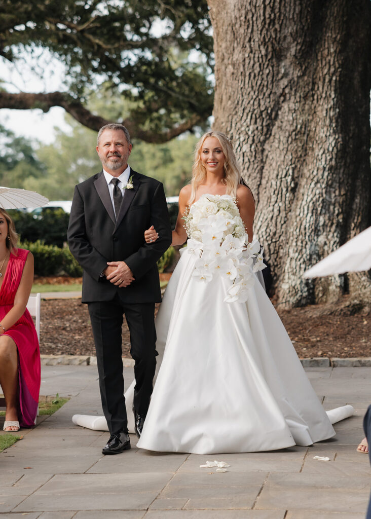 bride walks down the aisle at the Reed House in Jackson, MS