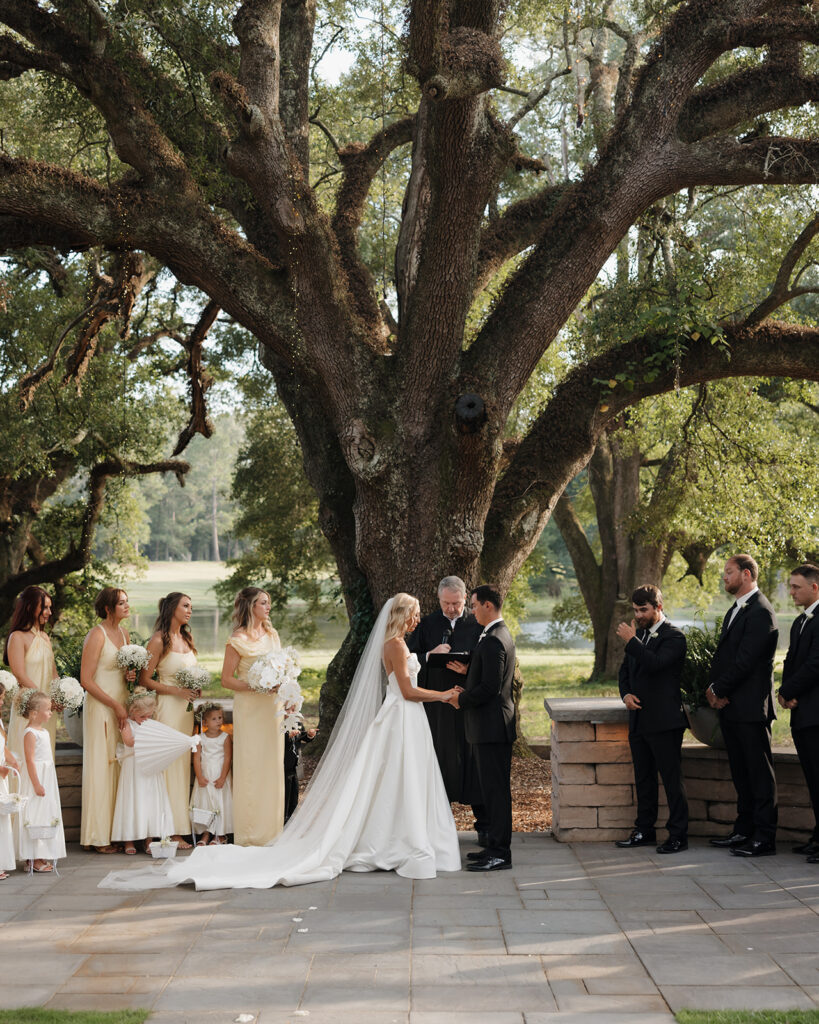 bride and groom exchange rings at the Reed House in Jackson, MS