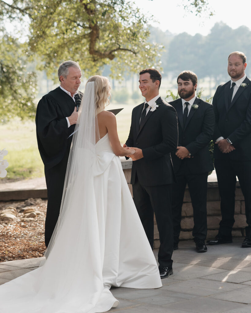 groom smiles at his bride