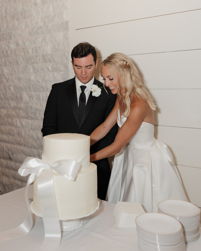 bride and groom cut the cake