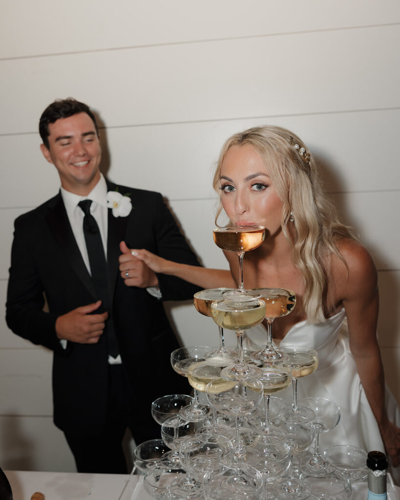 bride sips champagne tower