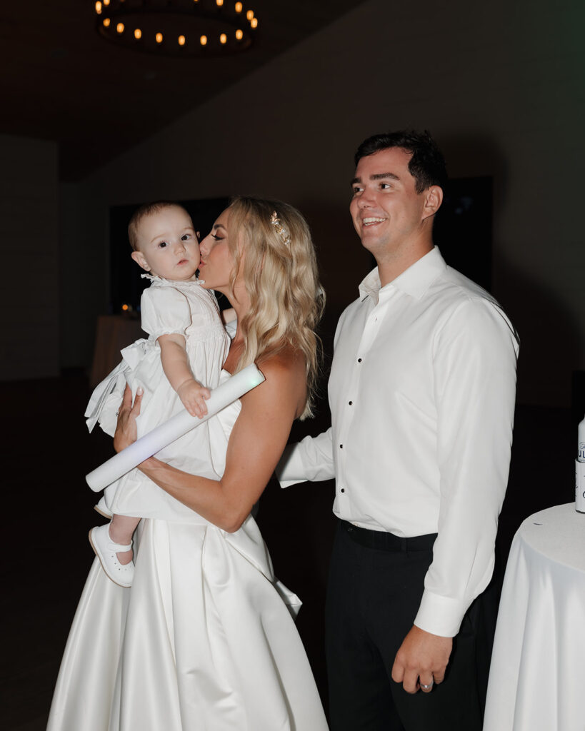 bride kisses little girl's cheek