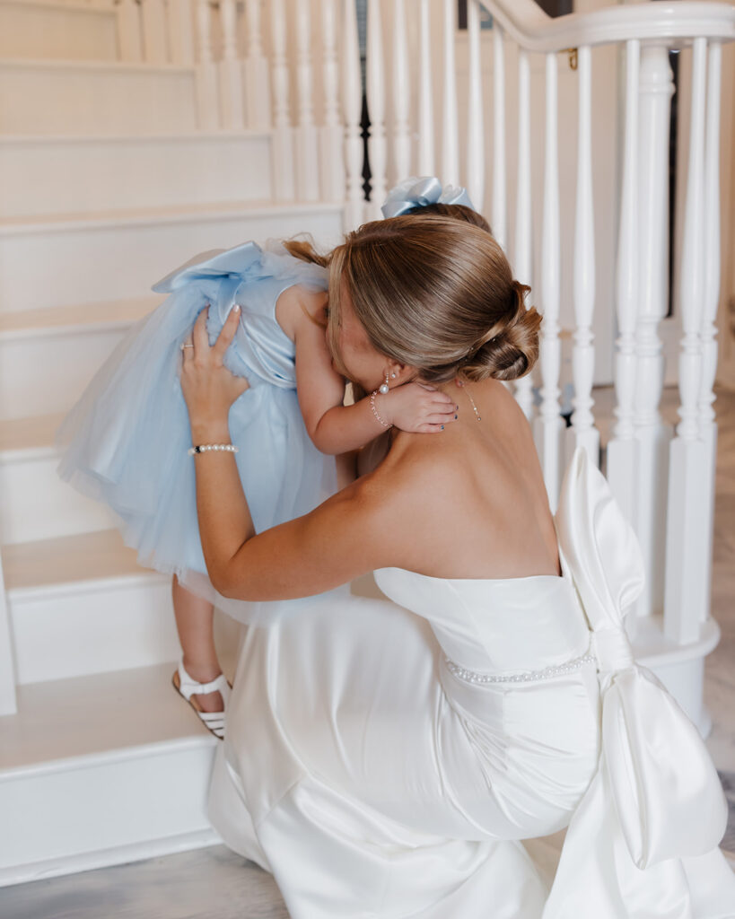 bride hugs flower girl