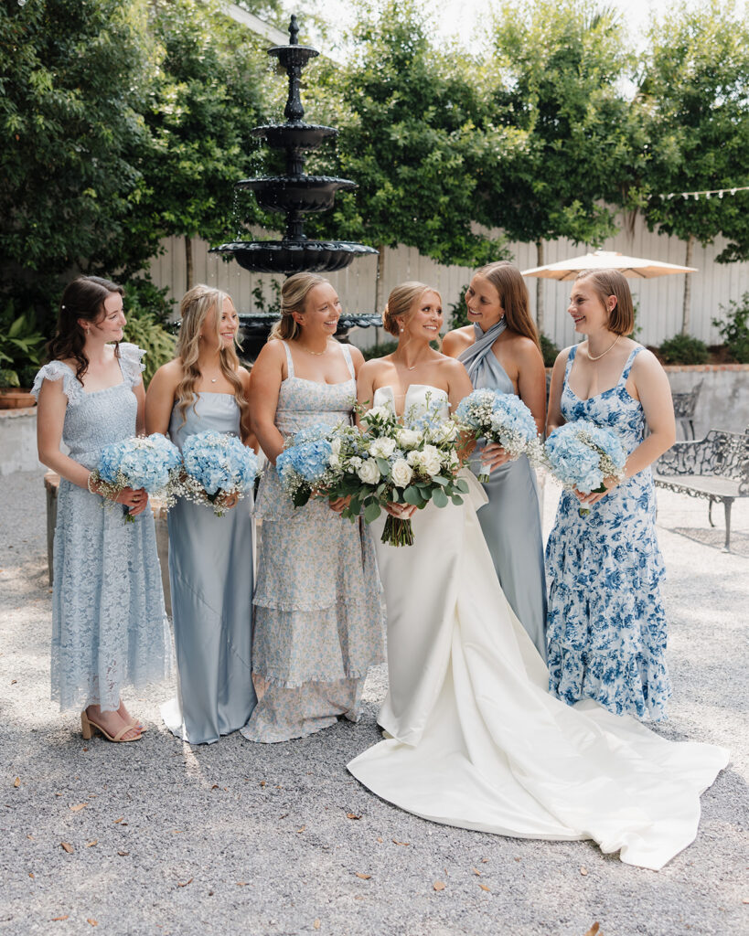 bride smiles with her bridesmaids