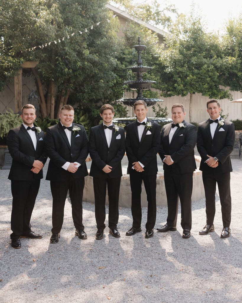 groom poses with his groomsmen