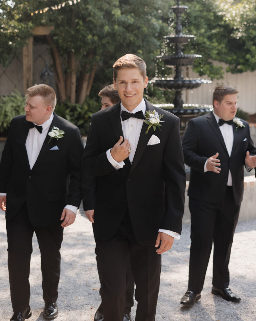 Groom walks with his groomsmen