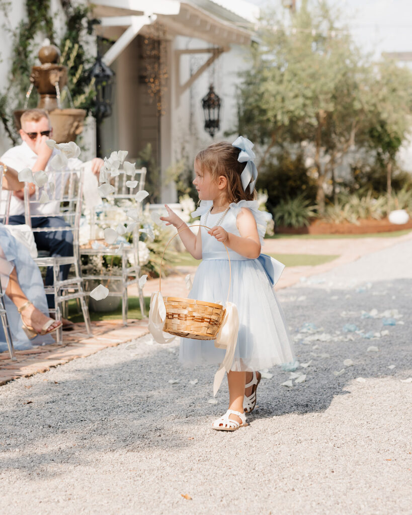 flower girl throws flower petals