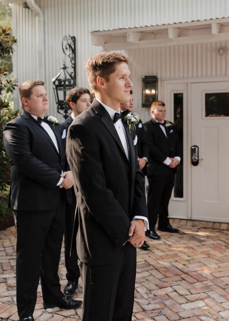 groom reacts to bride walking down the aisle