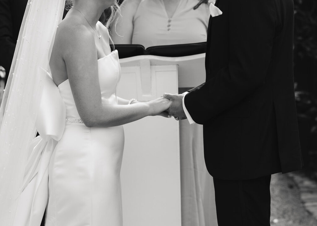 bride and groom hold hands