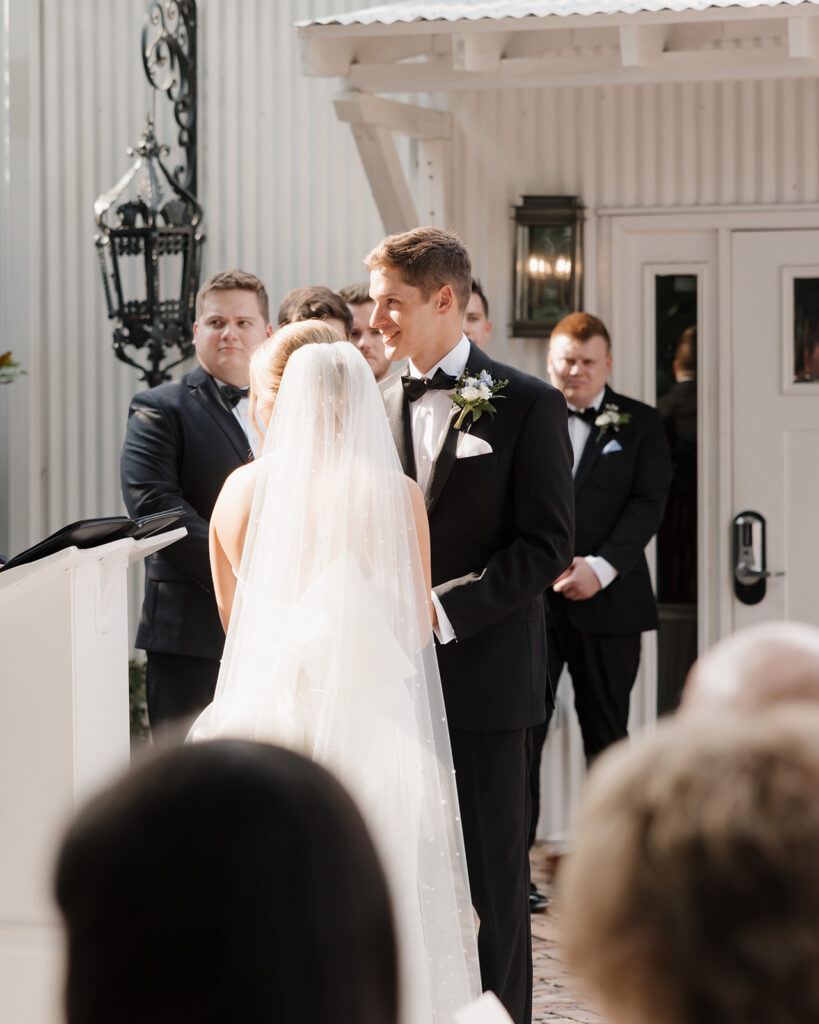 groom smiles during ceremony