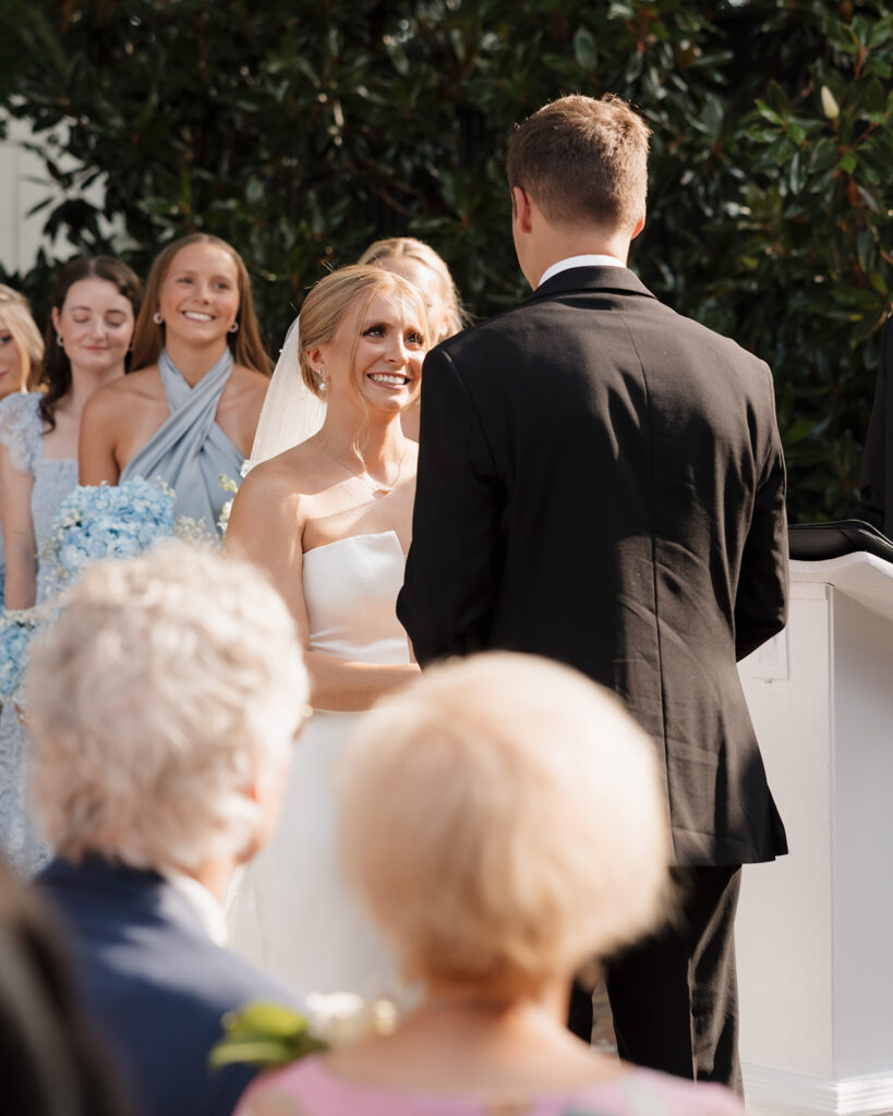 bride smiles at her groom