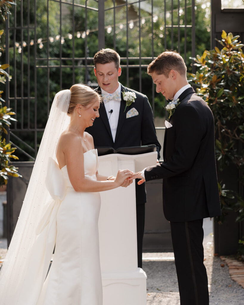 bride and groom hold hands during their wedding ceremony